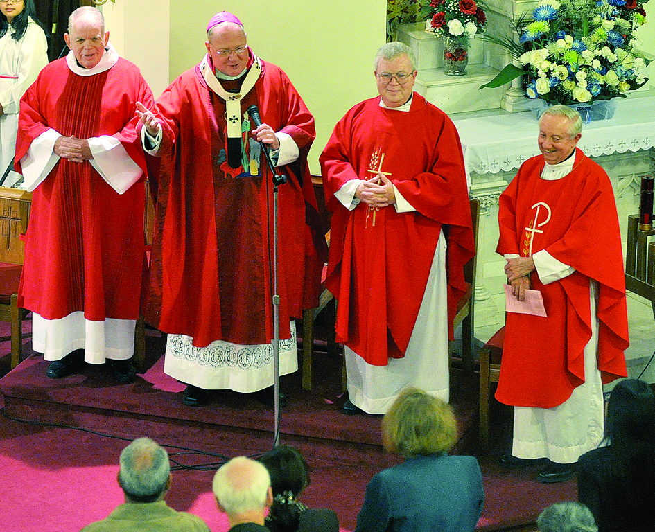 ANNIVERSARY—Standing together during the liturgy, are, from left, Deacon Joseph Mulryan, who formerly served at the parish; Archbishop Dolan; Father Edward O’Halloran, the pastor; and Msgr. George Thompson, a former pastor who’s now at St. Patrick’s, Bedford.