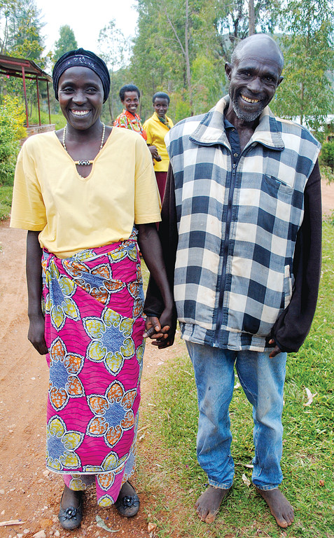HAND-IN-HAND—Viviane N’Habimana, left, a genocide survivor, clasps the hand of Boniface Hakizimana, a genocide perpetrator, outside Rugango Parish in rural Rwanda. Hakizimana had come to her pleading for forgiveness for his sins. She accepted and the two are now friends.