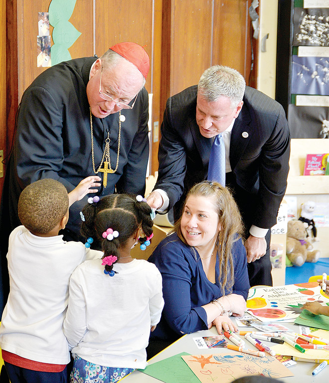 Prekindegarten students at Catherine Corry Early Childhood Academy in the Bronx chat with Cardinal Dolan and Mayor Bill de Blasio before a press conference discussing universal prekindergarten March 6. With them is a teacher at the school.