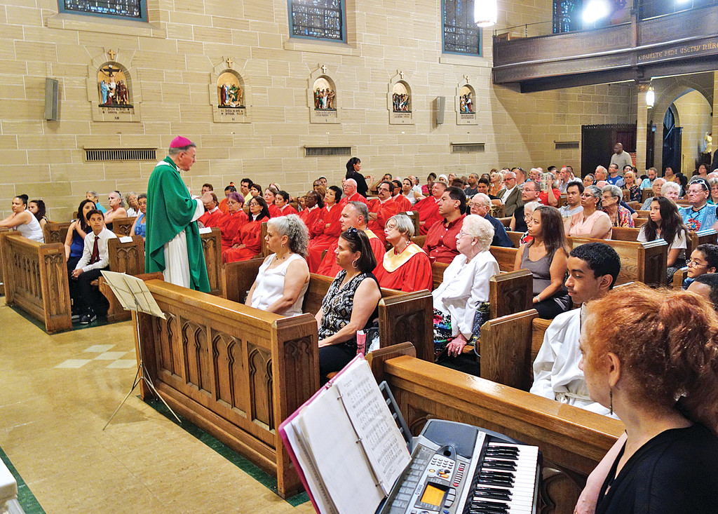 Auxiliary Bishop Gerald Walsh, above, addresses congregation at the Sign Language Mass for Deaf People July 19 at St. Elizabeth of Hungary Church in Manhattan.