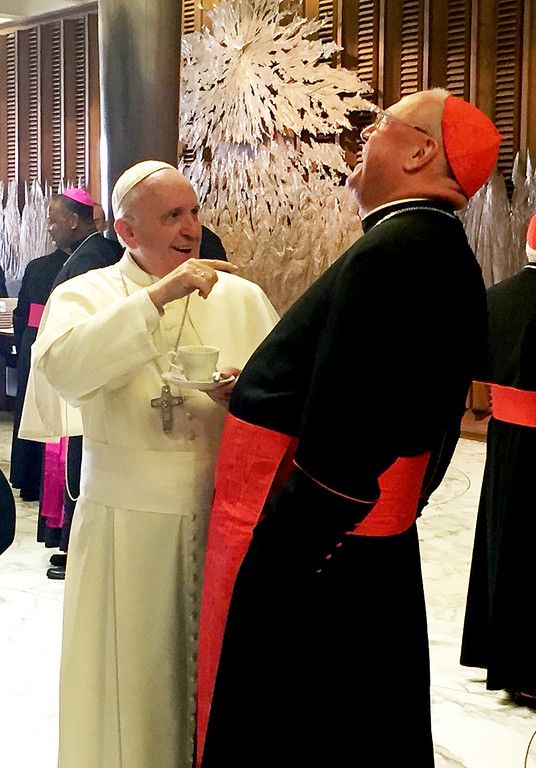 JOYFUL RECOLLECTION—Pope Francis and Cardinal Dolan fondly recall the pontiff’s recent visit to New York during a break at the Synod of Bishops on the Family.