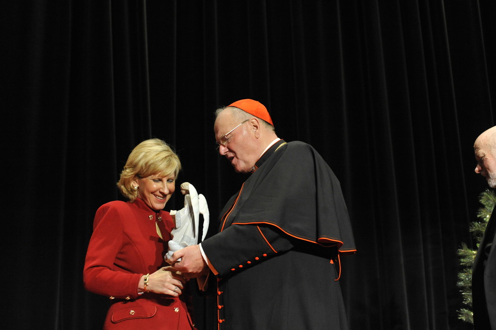 Cardinal Dolan presents the Christmas Angel Award to Cathy Martine-Dolecki.