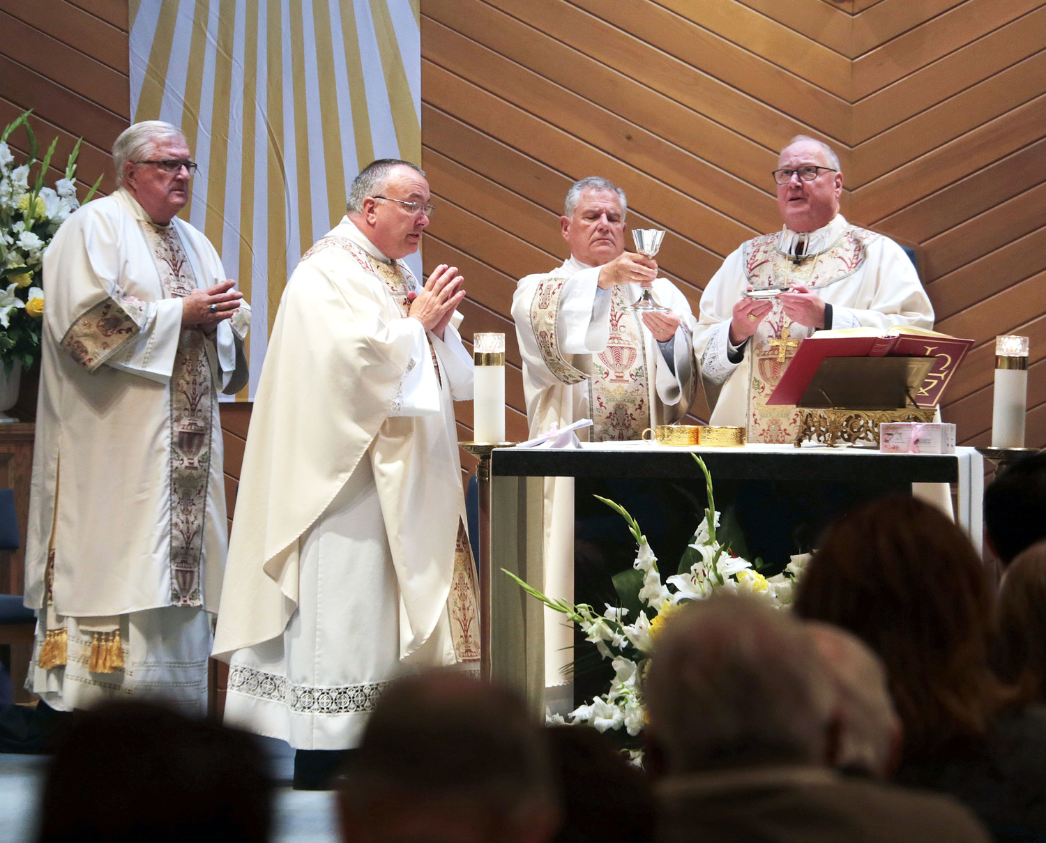 Cardinal Dolan served as principal celebrant and homilist at the 11:30 a.m. liturgy. To his left is Deacon Philip Marino. At far left, front, is the pastor, Father Herbert DeGaris. Behind him is Deacon John Sadowski. The parish recently began the public phase of the major capital campaign Renew + Rebuild. To date, $440,000 in pledges have been made toward its goal of $839,000.