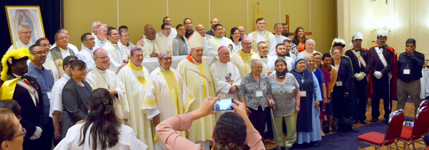 Bishops and clergy from the eight Catholic dioceses in New York state gather with the Region 2 Encuentro leaders and the consultative team following the closing Mass of the June 22-24 Region 2 V Encuentro at the Desmond Hotel in Albany. At the center is Bishop Nicholas DiMarzio, the principal celebrant of the Mass.