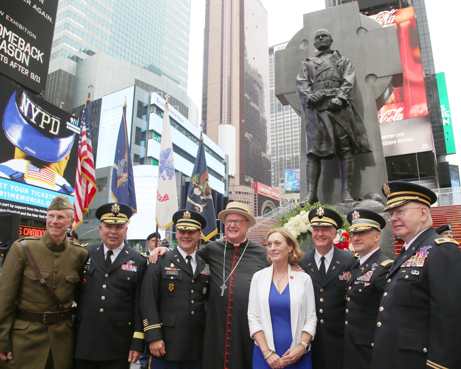 Cardinal Dolan joins military personnel and Dr. Libby O’Connell of the U.S. World War I Centennial Commission and the New York World War I Centennial Committee following a wreath laying ceremony June 27 at Father Duffy Square in Manhattan’s Times Square. Behind them is the iconic statue of the renowned military chaplain who was a priest of the archdiocese.