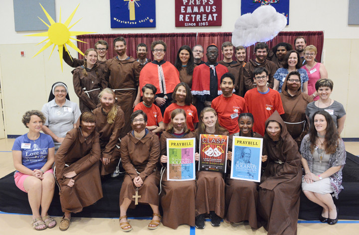 PERFORMERS’ PORTRAIT—Above, teens in costume and adults working behind the scenes on “Solanus: Blessed in America, The Story of Blessed Solanus Casey, O.F.M. Cap.” take a group photo July 30. The musical, written by Father Erik Lenhart, O.F.M. Cap., is being performed Friday, Aug. 3, in St. Genesius Gymnasium on the Catholic Youth & Family Ministries campus in Garrison.