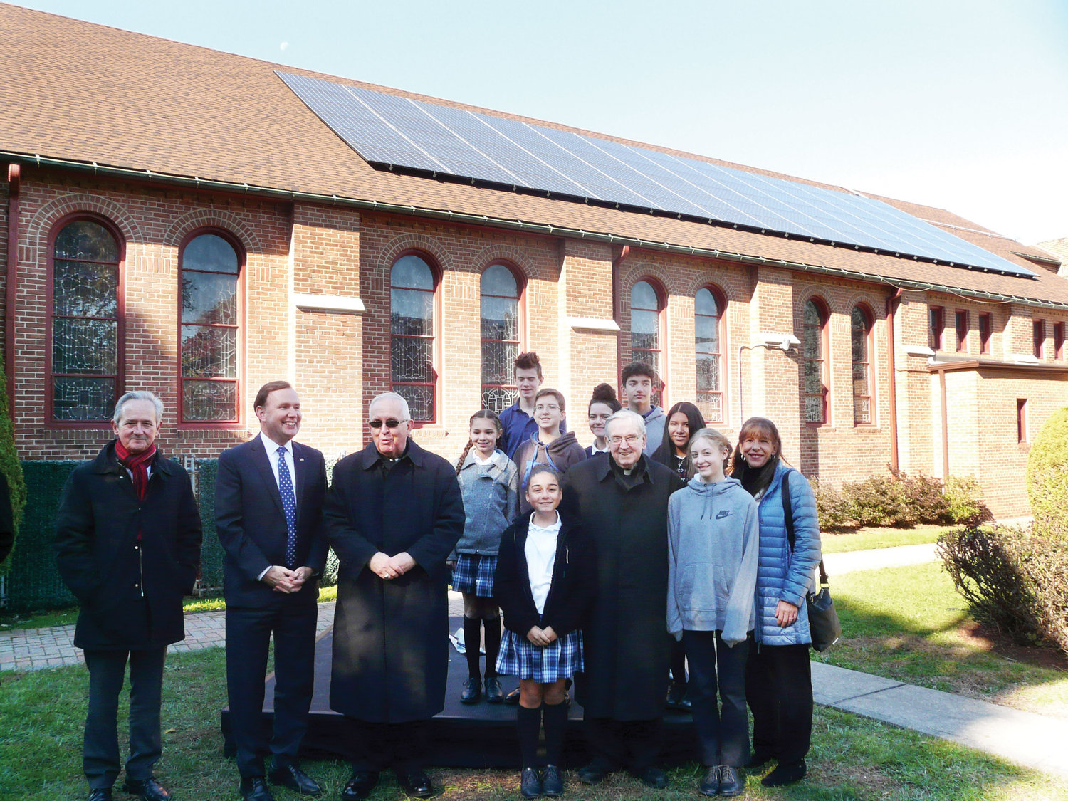 Joining Auxiliary Bishop John O’Hara, third from left, and Msgr. Peter Finn, administrator of Blessed Sacrament parish, along with eighth-graders from Blessed Sacrament School, were Martin Susz, director of energy management for the archdiocese, far left, and New York State Assembly member Michael Cusick.