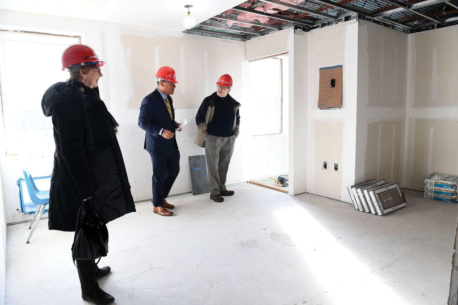 Hugo Pizarro, a senior vice president and chief experience officer for ArchCare, center, shows Pat and Thomas Alberto the construction progress on ArchCare’s $3 million project to provide independent housing for young adults with autism at St. Teresa parish on Staten Island Jan. 17.