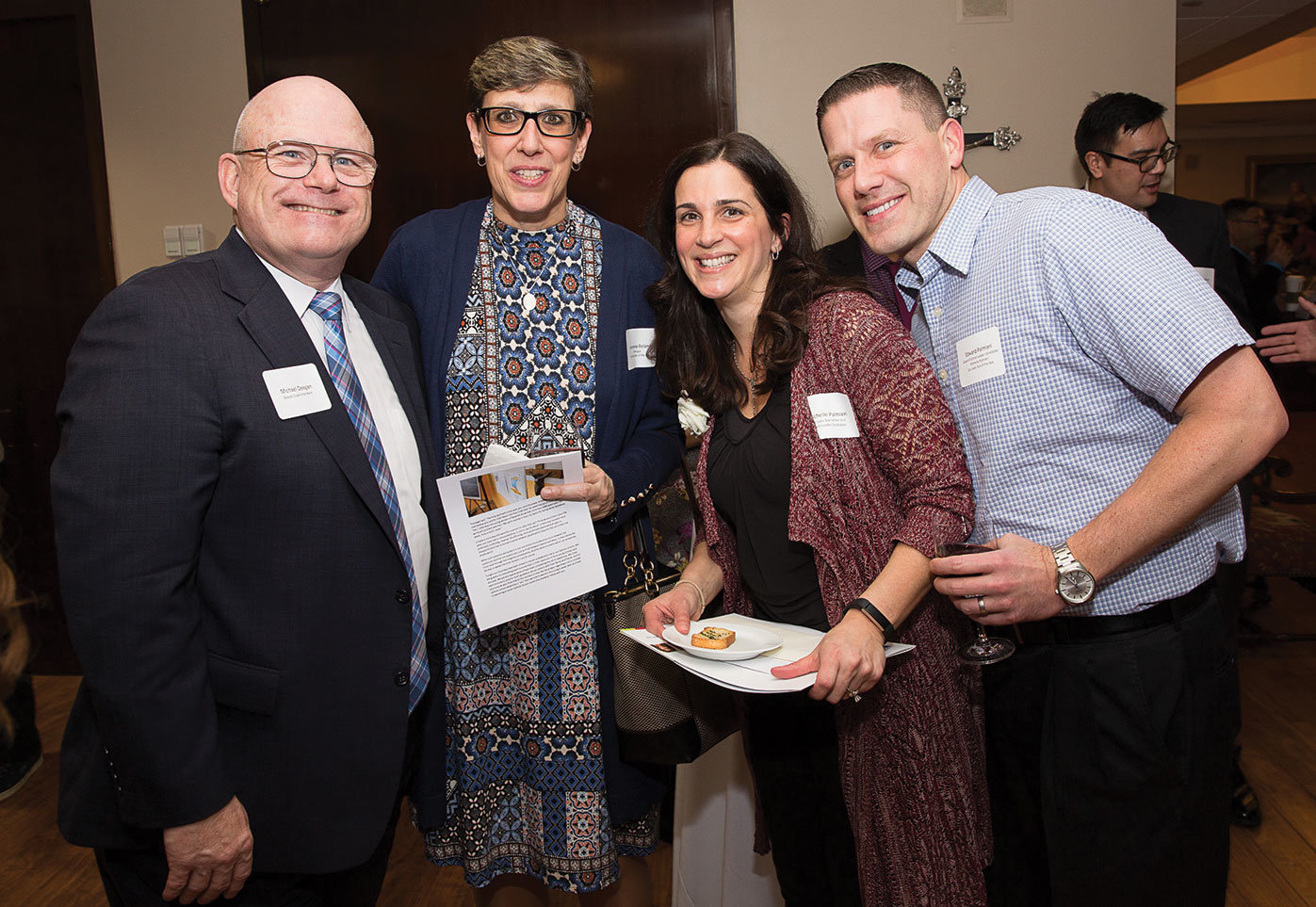 Michael Deegan, far left, deputy superintendent of schools in the archdiocese, joins Jeannine Roland, principal of Our Lady Star of the Sea, Staten Island; Michelle Palmieri, teacher at Our Lady Star of the Sea; and Edward Palmieri, Ms. Palmieri’s husband, at the Evening of Teacher Recognition and Call to Discernment at the New York Catholic Center in Manhattan Jan. 24. Ms. Palmieri was one of more than 40 distinguished teachers in the archdiocese invited to apply for a Curran Fellowship.