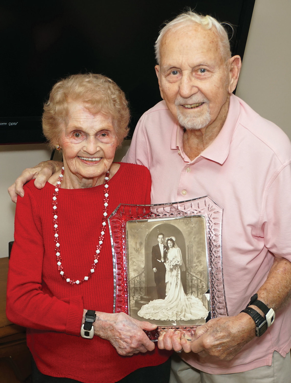 HAPPY COUPLE—Josie Maciocha, left, and her husband, Stanley, hold a treasured photo from their wedding day of Jan. 24, 1943. The parishioners of Transfiguration in Tarrytown are the longest-married couple in the archdiocese following an annual search by the archdiocesan Family Life Office.