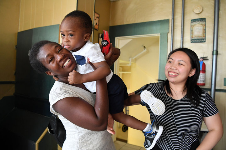 IN GOOD HANDS—University of Notre Dame student Jennifer Huang, right, joins Koussoube Fasanewende and her son David, 17 months old, at Good Counsel Home on Staten Island. Jennifer is serving as a resident assistant this summer with sponsorship from the Notre Dame Club of Staten Island.