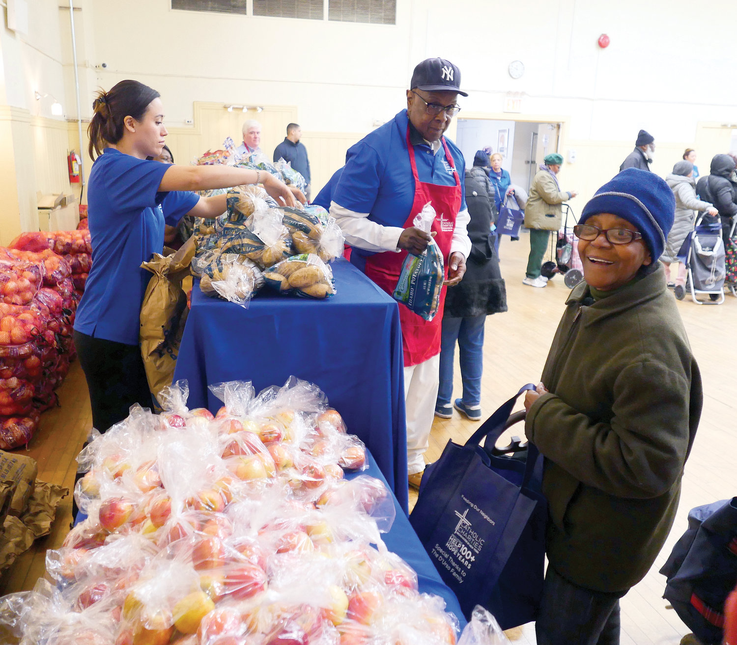 Volunteers and recipients are shown at the community center, located on West 134th Street.