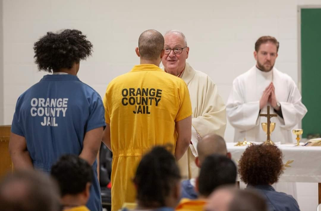Cardinal Dolan distributes Communion during the Mass he offered Nov. 25 for more than 50 inmates at Orange County Correctional Facility in Goshen. The cardinal visited with each inmate after Mass, and before visiting the correctional facility, Cardinal Dolan greeted Orange County Sheriff Carl E. DuBois and his staff. “It’s an honor and privilege to welcome Cardinal Dolan to our facility to give blessings to my staff and those who will be spending Thanksgiving in our facility,” said Sheriff DuBois.