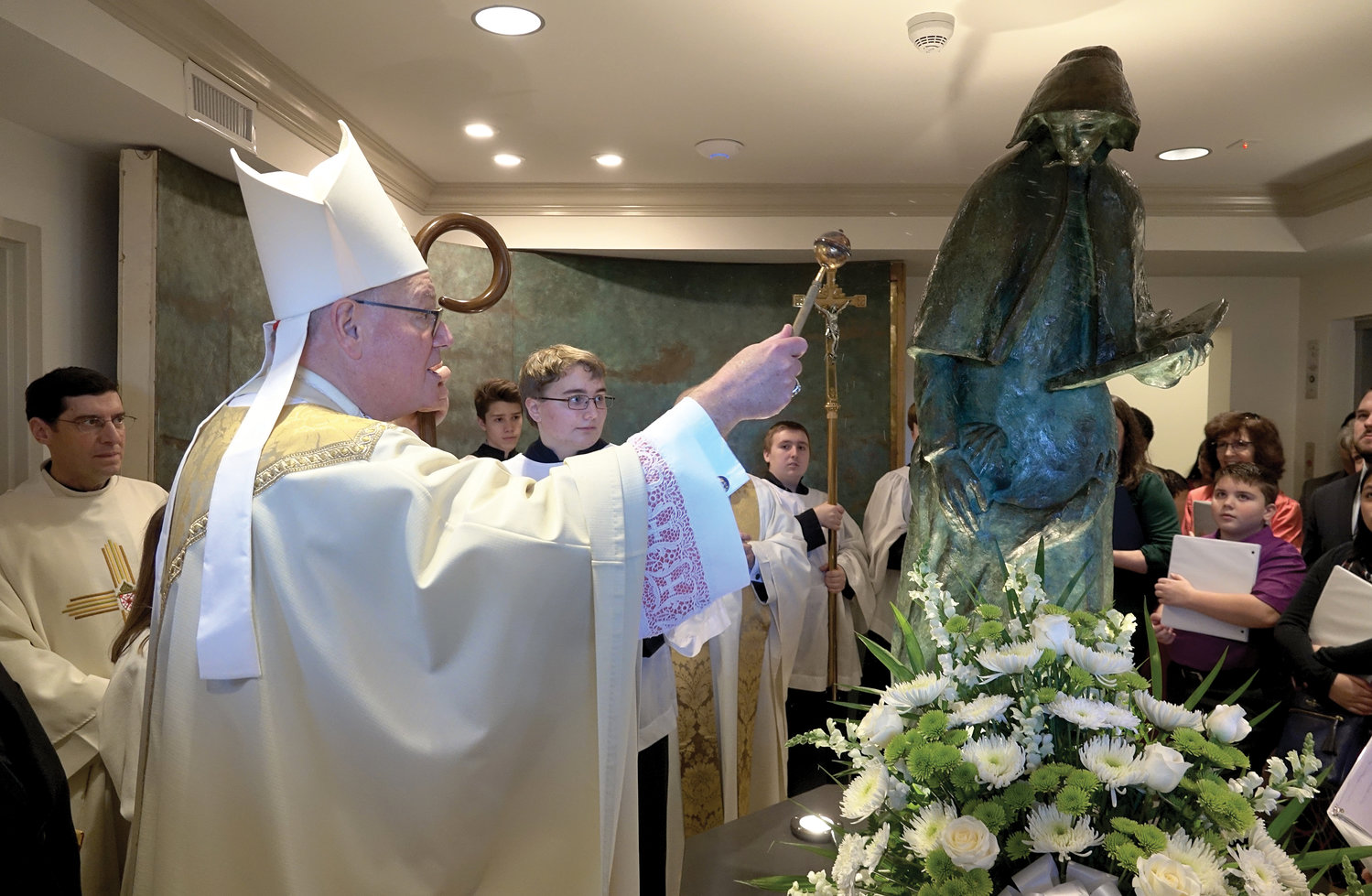 Cardinal Dolan blesses the St. Elizabeth Ann Seton statue in the main lobby of the Seton Parish Center in Shrub Oak Jan. 12.