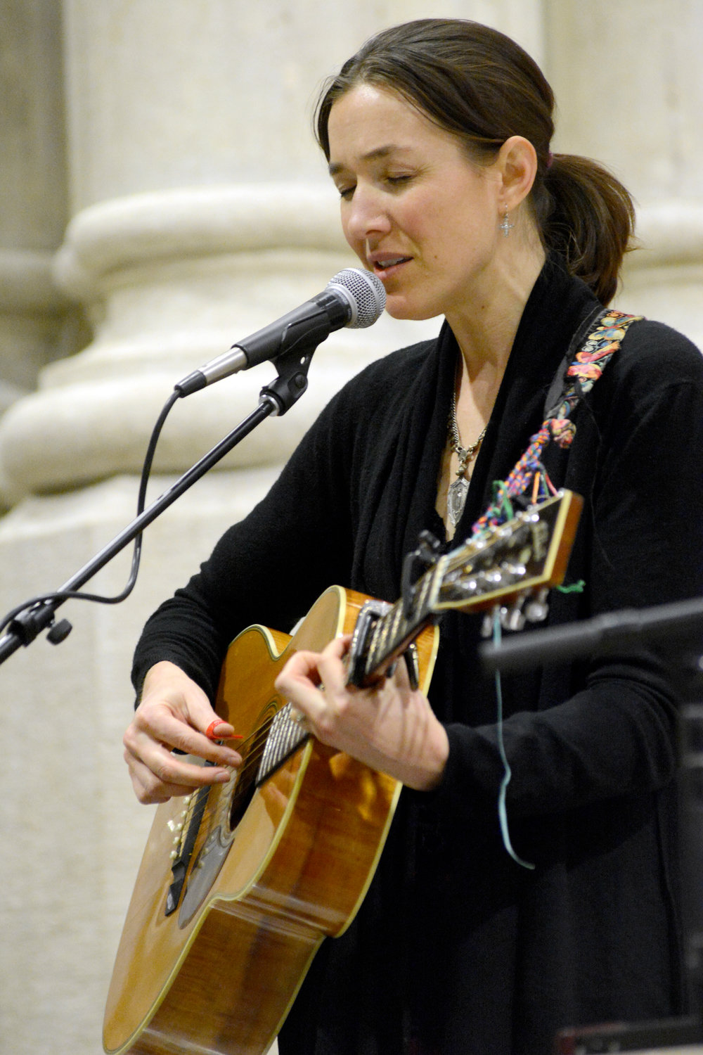 Danielle Rose sings before the March 4 Mass, which was sponsored by the archdiocesan Office of Young Adult Outreach.