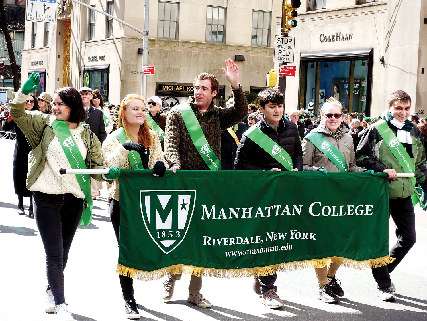 Students from Manhattan College stride with smiles on their faces during the 258th New York City St. Patrick's Day Parade on Fifth Avenue last March.