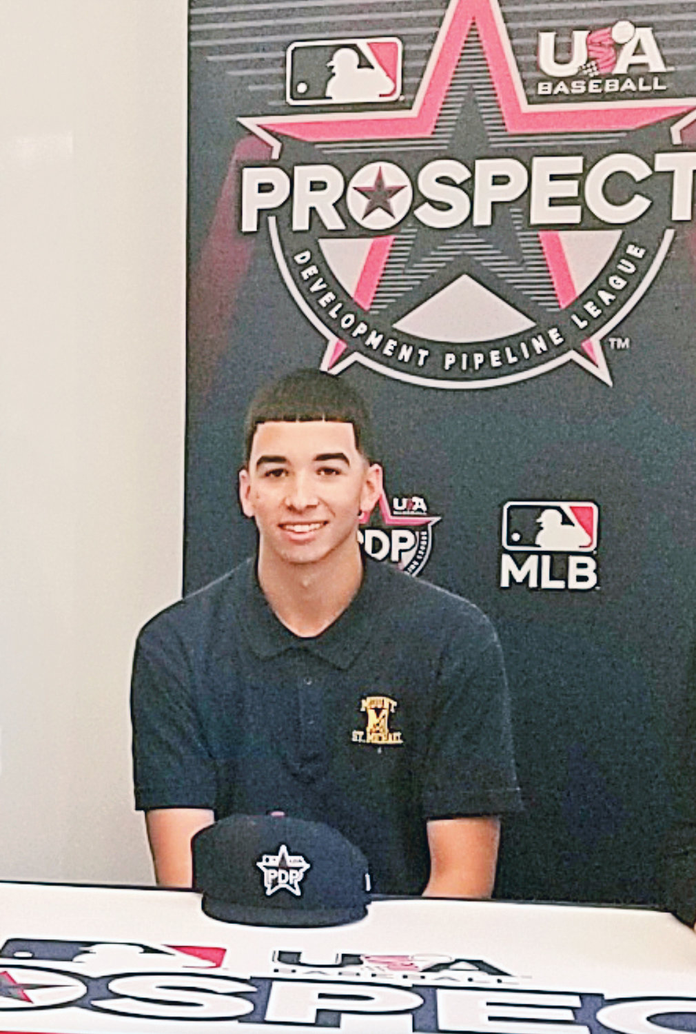 OFF TO PROS—Mount St. Michael Academy graduate Alex Santos was selected by the Houston Astros with their first pick in the 2020 Major League Baseball Draft June 11. In this photo, Santos celebrates his selection to the inaugural Prospect Development Pipeline League with family, friends and coaches at Mount St. Michael in 2019.