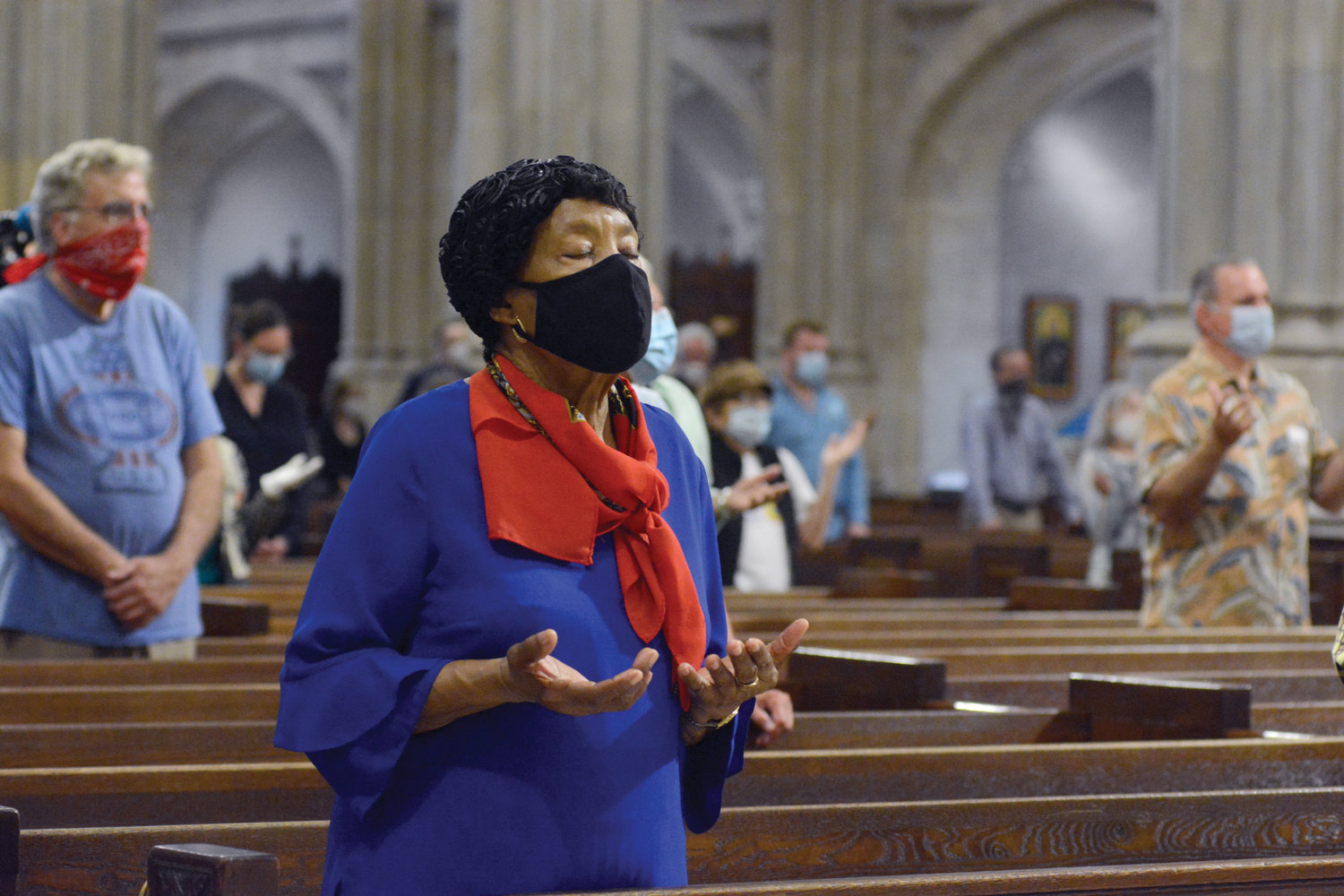 The faithful maintain required social distance in the pews and wear protective face coverings as they pray during the 10:15 a.m. Mass June 28 in St. Patrick’s Cathedral.