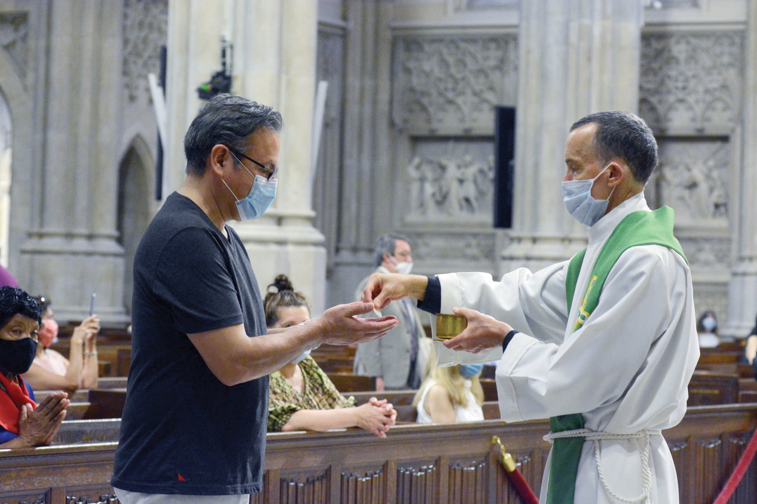 Father Donald Haggerty distributes Communion.