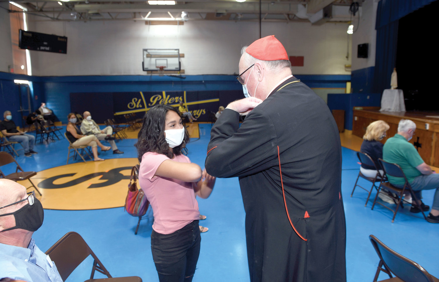 Cardinal Dolan greets 14-year-old Isabella Munoz after celebrating Mass in St. Peter’s School gymnasium in Haverstraw June 27. Isabella underwent a heart transplant two years ago, and the cardinal regularly visited her and prayed with the family in the hospital.