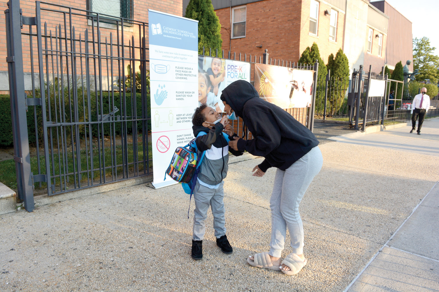 Chelsea Thompson kisses her son, first-grader Chase Torres, before she drops him off at Our Lady of Grace School in the Bronx on the morning of Sept. 22. Our Lady of Grace and other Catholic schools throughout the archdiocese have opened for the 2020-2021 school year.