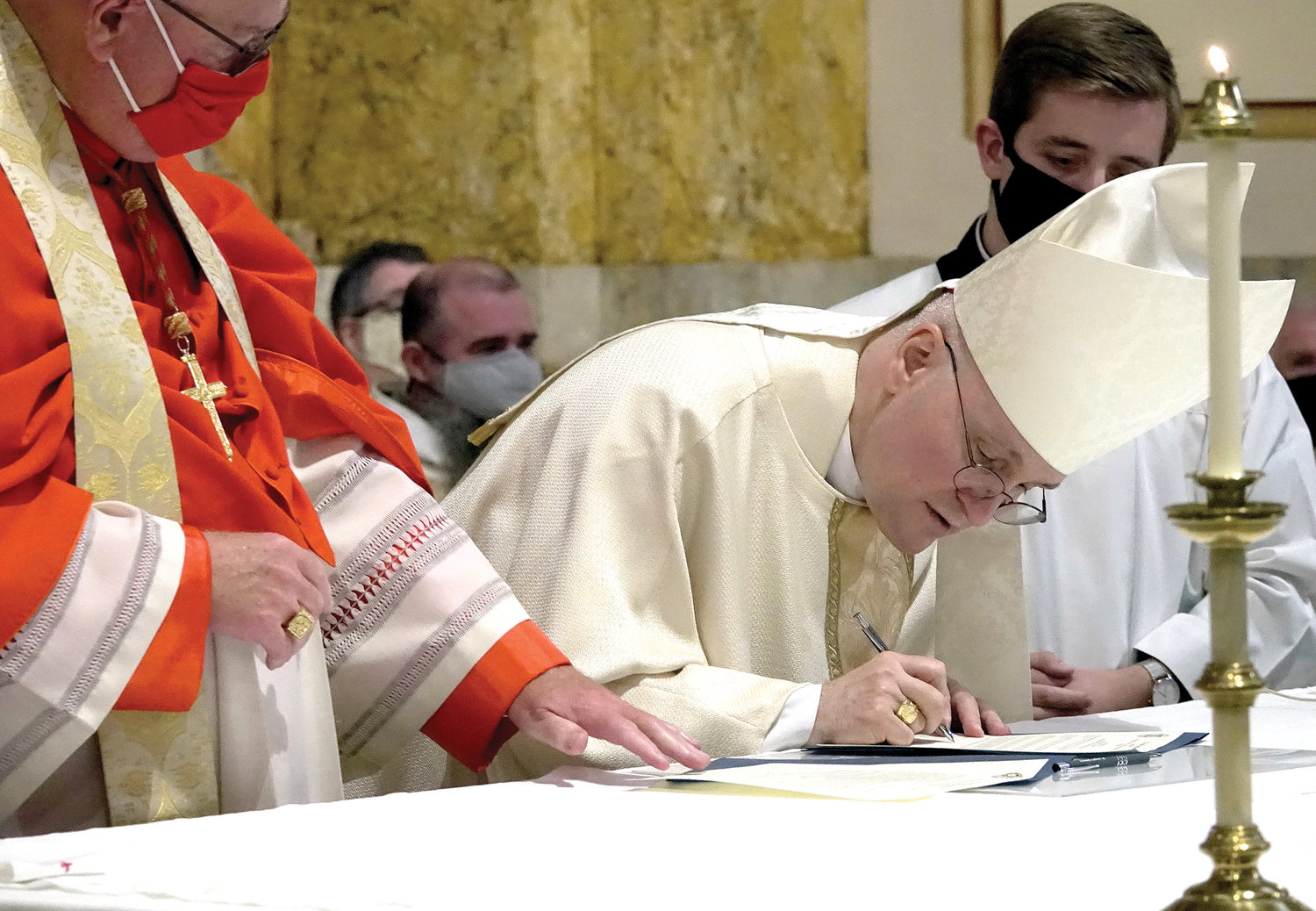 Auxiliary Bishop James Massa of Brooklyn signs oath of fidelity before Cardinal Dolan at the Sept. 13 Mass in which the bishop was officially installed as rector of St. Joseph’s Seminary, Dunwoodie.