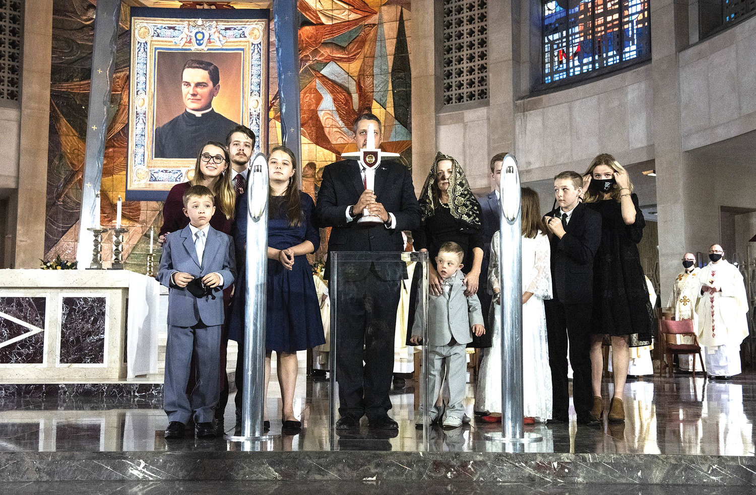 Michael “Mikey” McGivney Schachle, his parents, Daniel and Michelle, and several siblings stand with a relic during the Oct. 31 beatification Mass of Blessed Michael McGivney, founder of the Knights of Columbus, at St. Joseph’s Cathedral in Hartford, Conn. Daniel Schachle is holding a cross containing the McGivney relic.