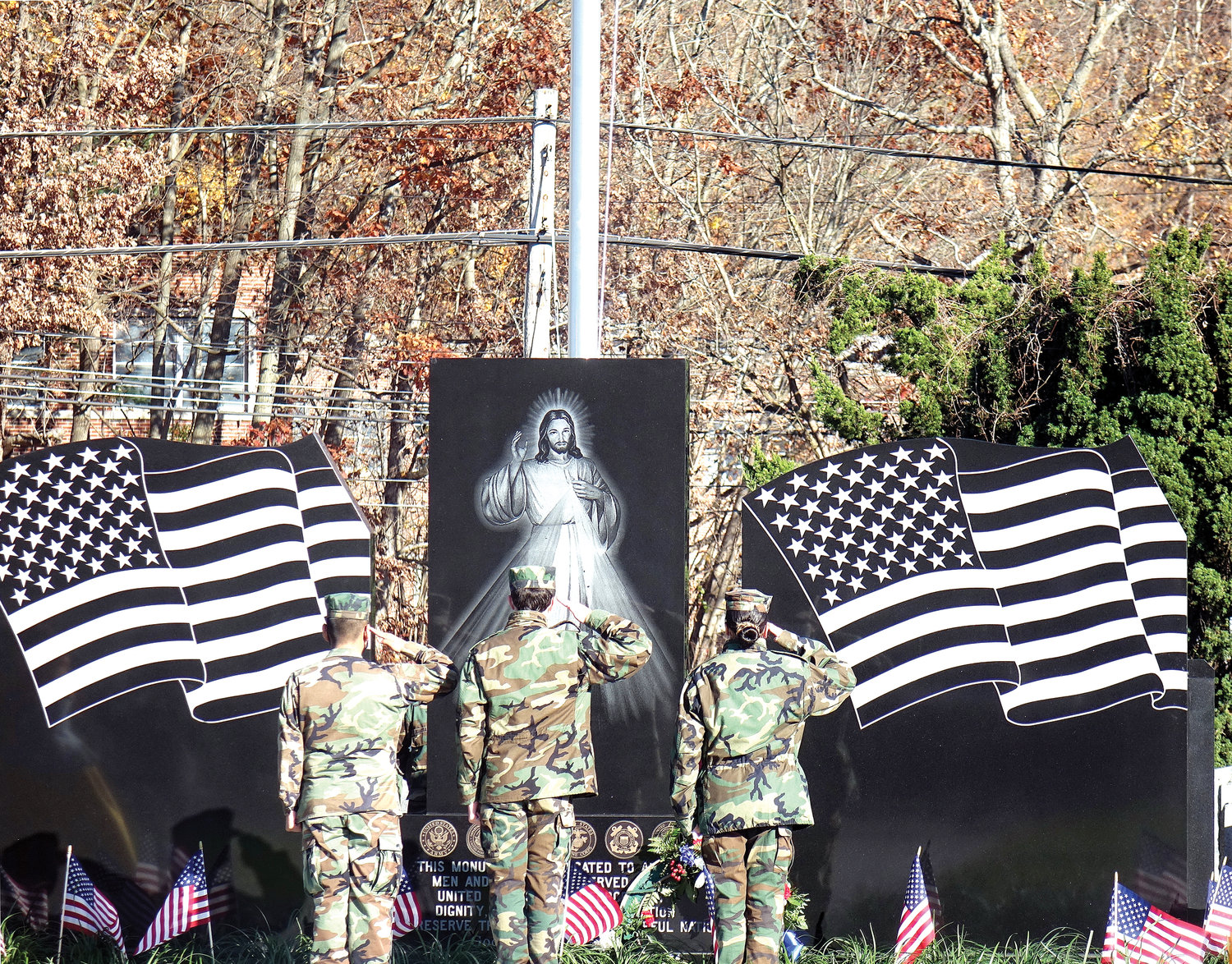 Soldiers offer salute at monument in the new 320-grave section for Catholic veterans of the U.S. armed services at Gate of Heaven Cemetery in Hawthorne Nov. 14.