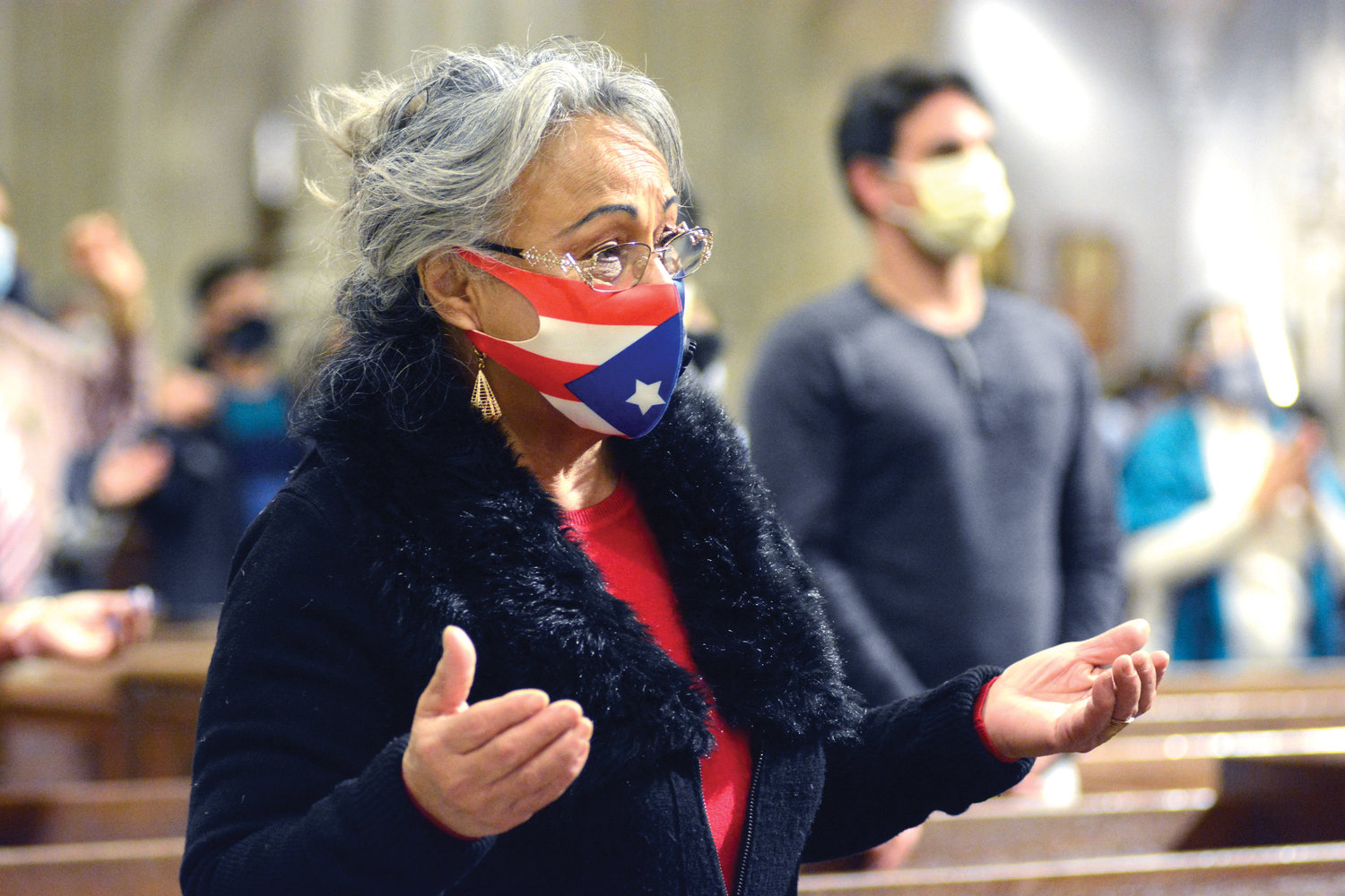 HER PRIDE SHOWS—A woman among the faithful wears a Puerto Rican flag face mask during the 40th annual Our Lady of Providence Mass at St. Patrick’s Cathedral. Auxiliary Bishop Edmund Whalen served as principal celebrant and homilist of the Nov. 15 Spanish-language Mass, which was livestreamed via the cathedral website. Our Lady of Providence is the patroness of Puerto Rico.