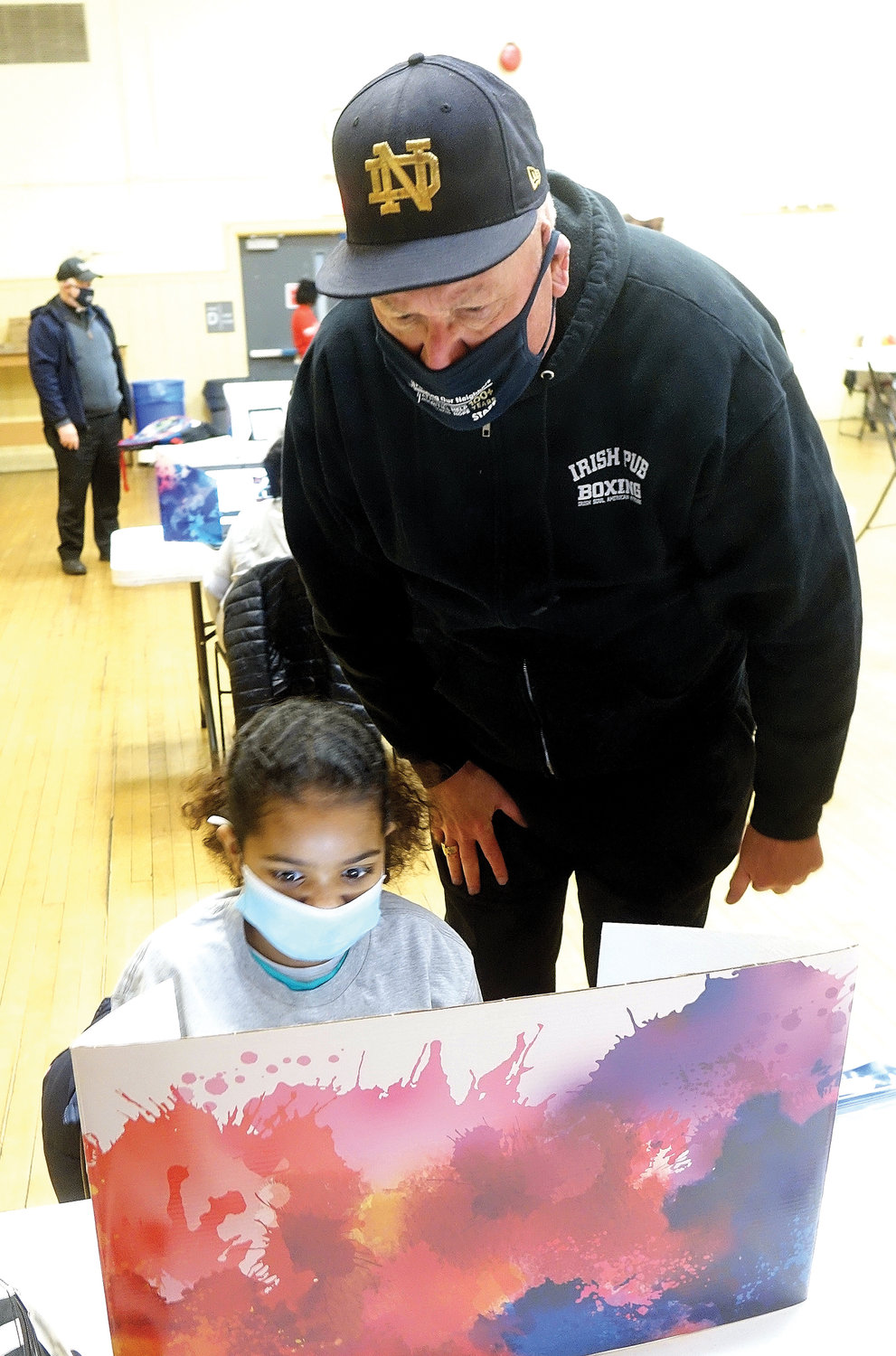 Cardinal Dolan visits with a budding artist in the center’s Early Education Center.