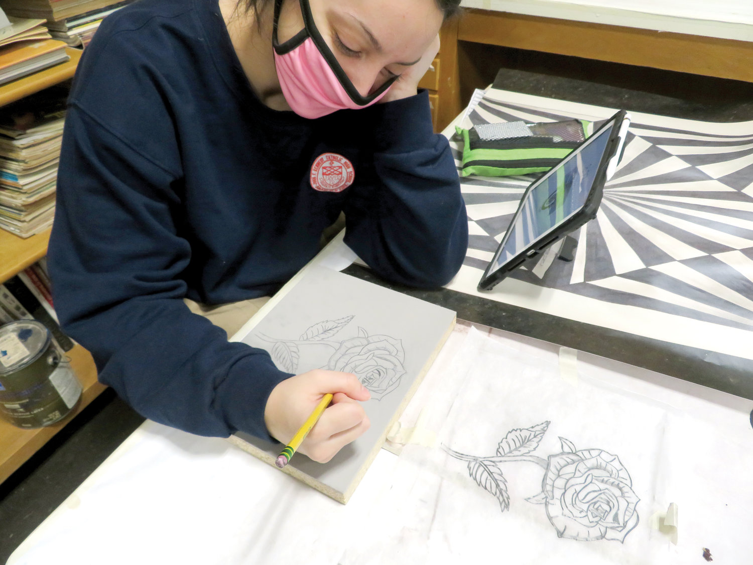 Students at John F. Kennedy Catholic Preparatory School in Somers are divided into two cohort groups that alternate weeks of in-person study with virtual instruction at home. Junior Valeria Acierno works on a drawing in studio art.