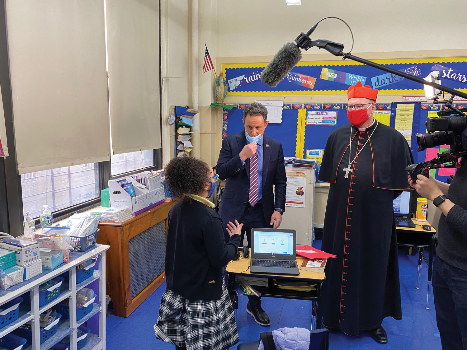 Second-grader Isabella Lluberes speaks with Brian Kilmeade, host of Fox & Friends, and Cardinal Dolan at Good Shepherd School in the Inwood section of Manhattan March 12. Fox & Friends, a national morning show on FOX News, aired a piece March 15 about Catholic schools’ success in safely reopening their doors last September.