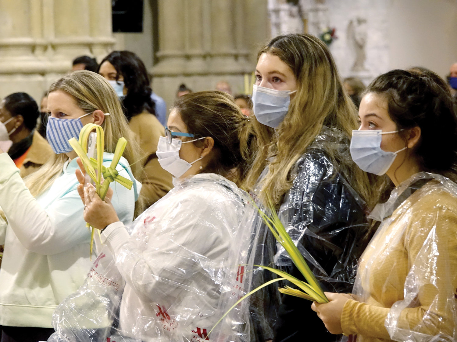 CATHEDRAL MEETING—A group of young women holding palm attend Palm Sunday Mass in St. Patrick’s Cathedral March 28. Cardinal Dolan is encouraging more Catholics to follow their example at parish churches around the archdiocese.
