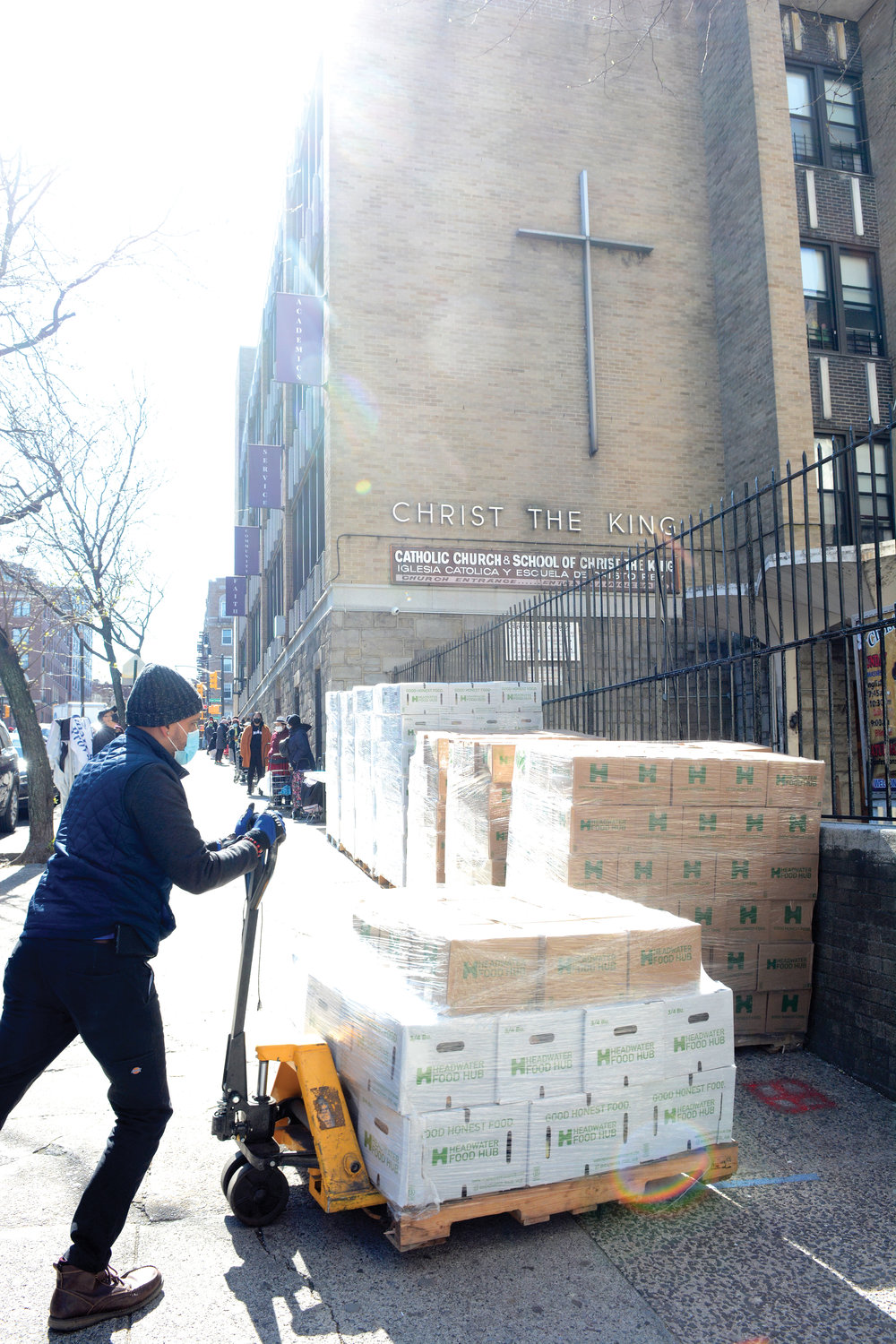 Catholic Charities staff and parish volunteers assist some of the 300 families at Catholic Charities pop-up food distribution at Christ the King parish in the Bronx April 23.