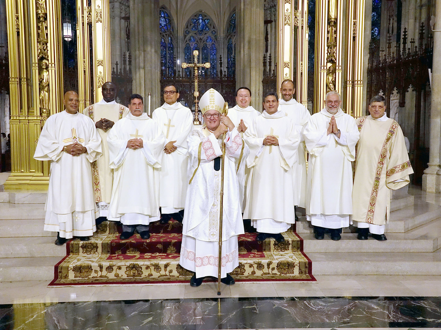 Cardinal Dolan, center in group photo, opposite page, was the principal celebrant and homilist during the June 19 Mass of Ordination for seven new permanent deacons at St. Patrick’s Cathedral. Also in the photo, taken after Mass, were, from left: Deacon James Bello, director of diaconate ministry and life; Deacon Martin Asiamah; Deacon Stephen DiGangi, Deacon Ferando Cortés, Deacon John Hum, Deacon Walter Lopez, Deacon Juan Martinez, Deacon Joseph Schiavone and Deacon Francis Orlando, director of diaconate formation.