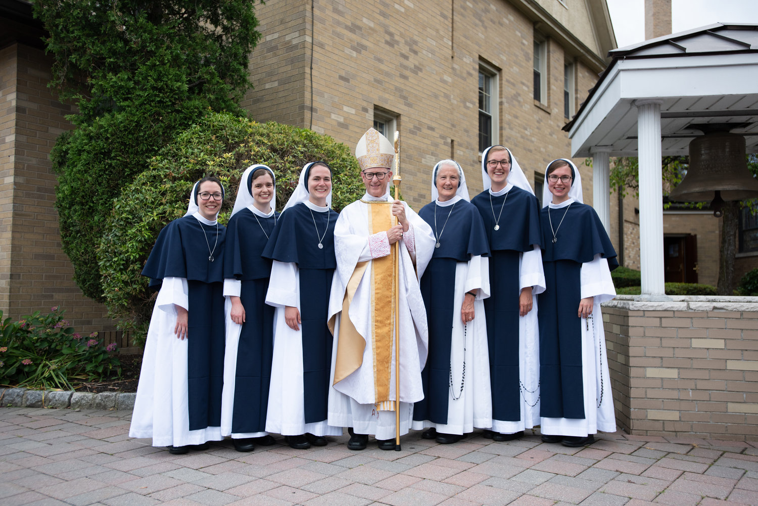 The five newly professed Sisters of Life join Bishop James Conley of Lincoln, Neb., who offered the Mass of Profession, and Mother Agnes Mary Donovan, S.V., superior general, outside Sacred Heart Church in Suffern June 26. They are, from left, Sister Eden Marie, S.V., Sister Rose Patrick O'Connor, S.V., Sister Maria Annunciata, S.V., Sister Elena Marie, S.V., and Sister Noelle Marie Bethlehem, S.V.