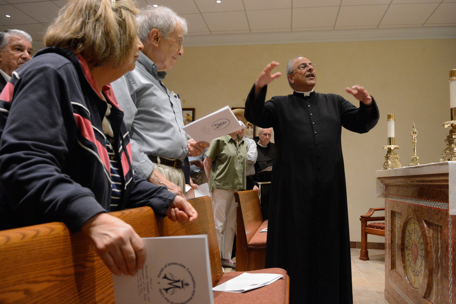 Father Anthony Sorgie, the pastor, and parishioners join in the chapel blessing.