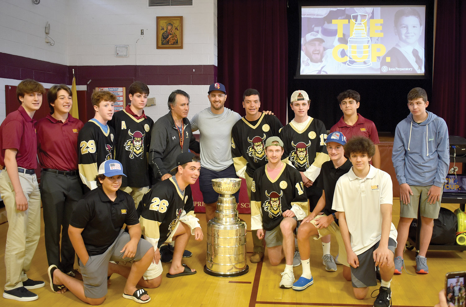 Kevin Shattenkirk, center, joins members of the hockey program during his visit to Iona Prep’s Lower School in New Rochelle with the NHL’s Stanley Cup July 17. Shattenkirk, a graduate of Iona Prep’s Lower School and now a member of the Anaheim Ducks, was a member of the 2020 Stanley Cup champion Tampa Bay Lightning.