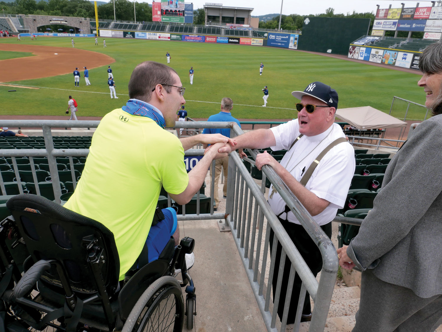 Cardinal Dolan greets a fan at the Frontier League baseball game between the host New York Boulders and the New Jersey Jackals at Palisades Credit Union Park in Pomona Aug. 4.
