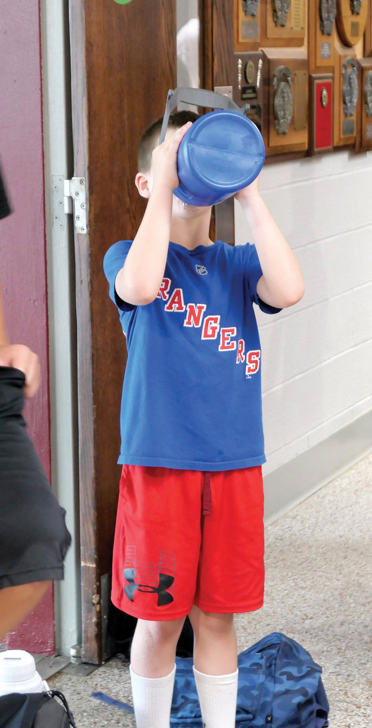 Liam Reynolds quenches his thirst during a break at camp.