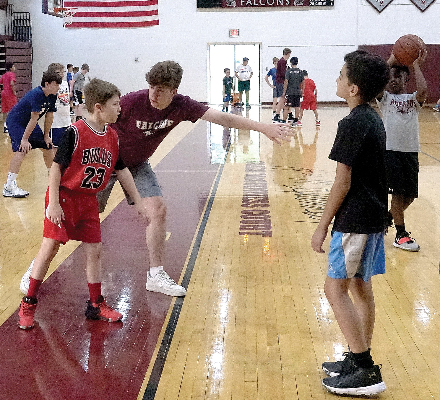 Camp counselor Shane Montgomery guides campers during the 2021 Falcon Basketball Camp at Albertus Magnus High School in Bardonia July 29.