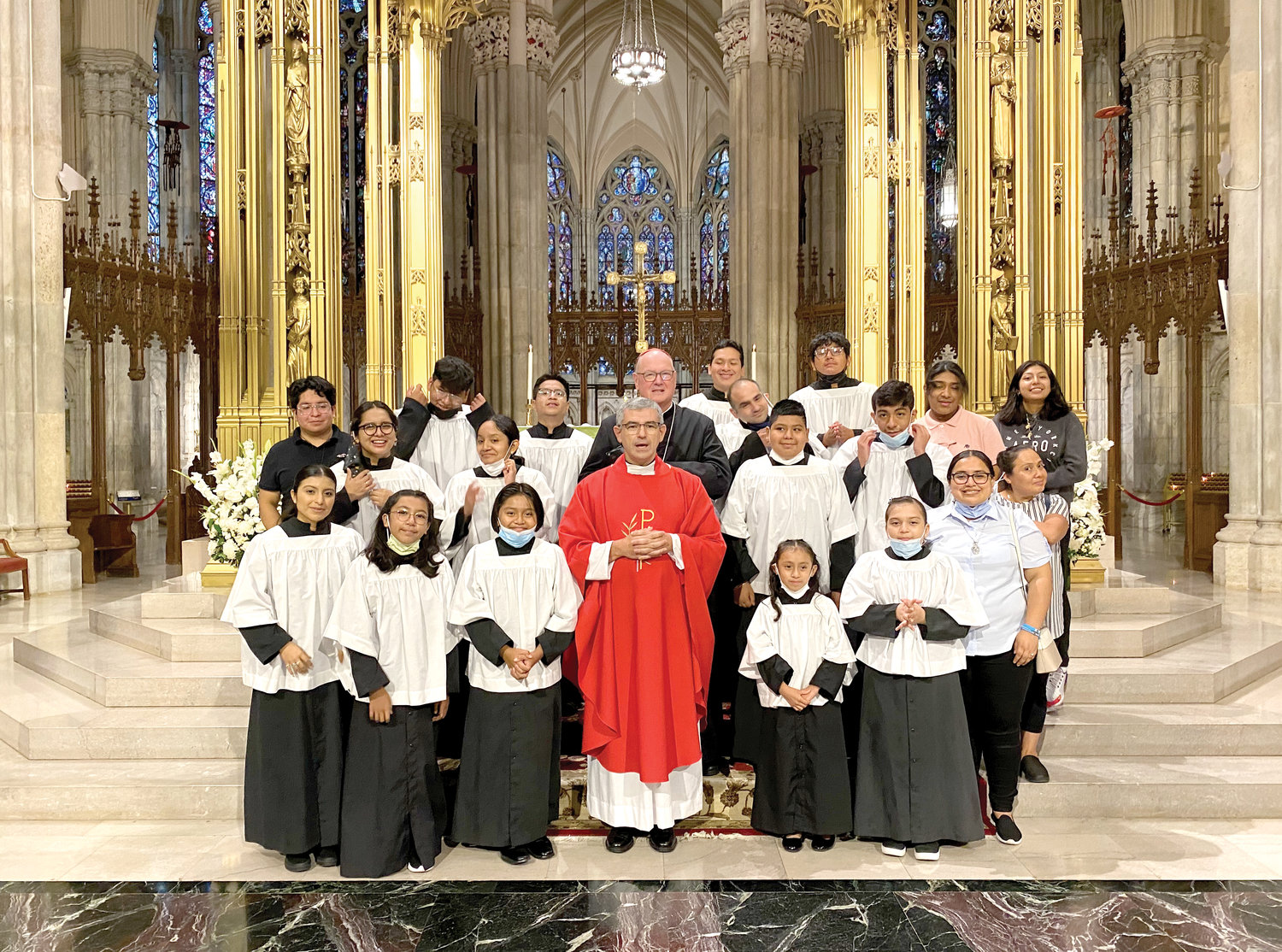 Altar servers from Our Lady of Mount Carmel parish in the Bronx join their pastor, Father Jose Felix Ortega, and Cardinal Dolan after the noon Mass at St. Patrick’s Cathedral Aug. 9, the feast of St. Edith Stein, a Carmelite known as St. Teresa Benedicta of the Cross. Also concelebrating was Father Donald Haggerty of the cathedral staff.