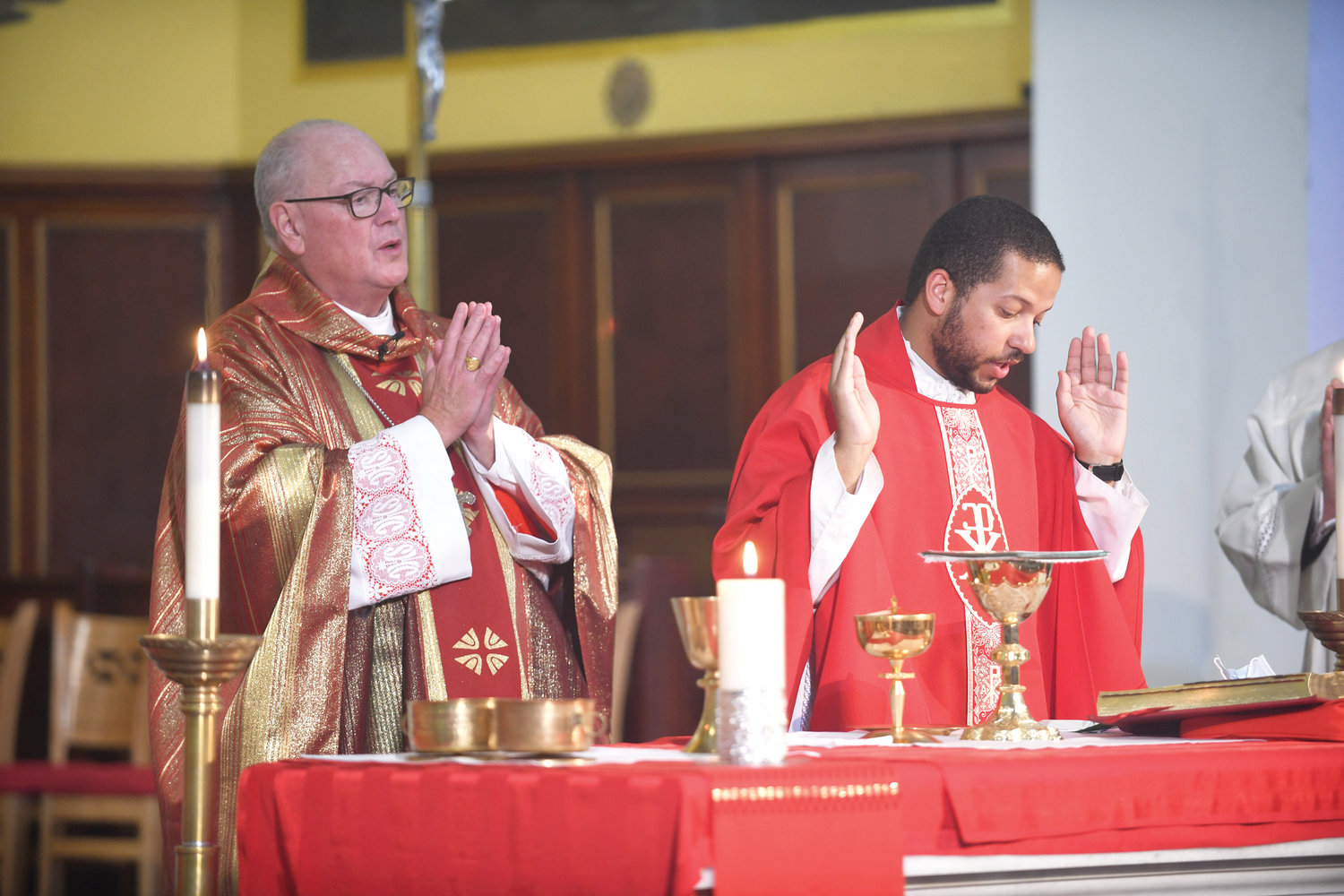 Cardinal Dolan serves as principal celebrant at the Mass of the Holy Spirit Sept. 17 for Cristo Rey New York High School at next door St. Cecilia and Holy Agony Church in East Harlem. Father Steven Gonzalez, a 2010 alumnus of Cristo Rey, to the cardinal’s right, was among the principal concelebrants.
