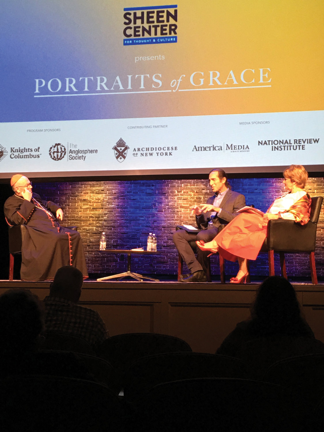 Cardinal Dolan took part in a discussion about the display in the center’s Loreto Theater. Jeffrey Bruno, photographer and curator of the exhibit, joined the discussion moderated by Amanda Bowman, Sheen Center board member.
