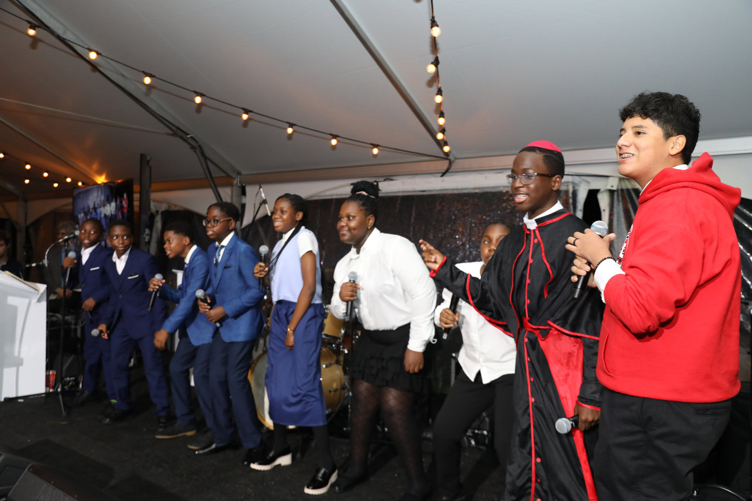 Students from St. Francis of Assisi School, including one dressed as a cardinal, perform at the Inner-City Scholarship Fund’s 50th Anniversary Celebration at Wave Hill in the Bronx Sept. 23.