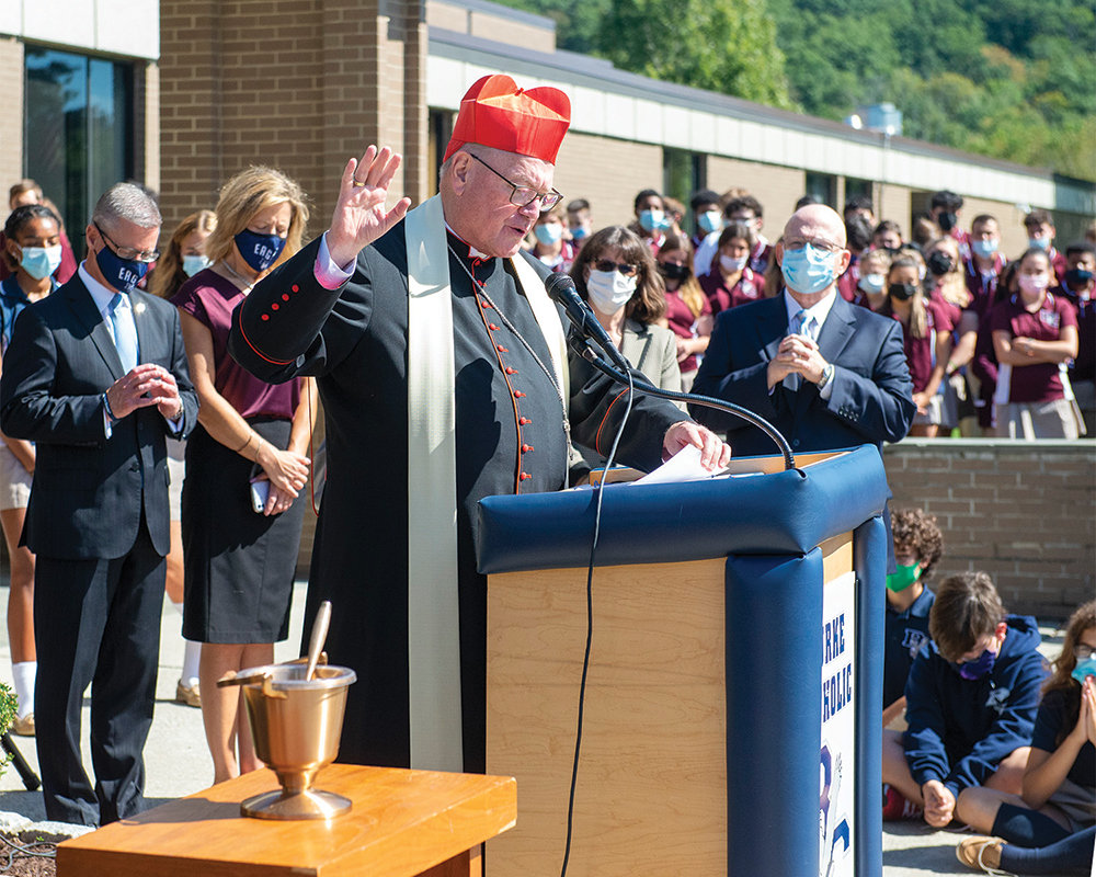 Cardinal Dolan offers a prayer before blessing and dedicating the new Burke Catholic Academy for students in grades 6 to 8 on the campus of John S. Burke Catholic High School in Goshen Sept. 24.