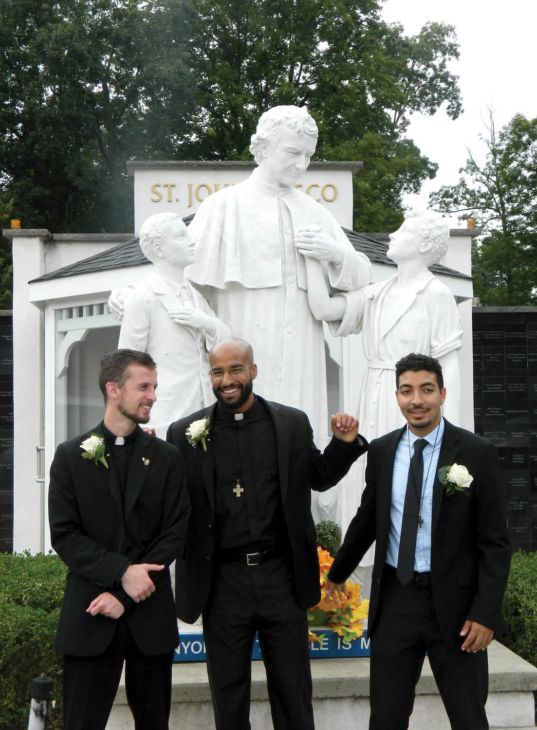 TAKING VOWS—After professing their final vows as Salesians of Don Bosco, Brother Joshua Sciullo, S.D.B., Brother Branden Gordon, S.D.B., and Brother Rafael Vargas, S.D.B., stand near a statue of St. John Bosco at the Marian Shrine in Stony Point.