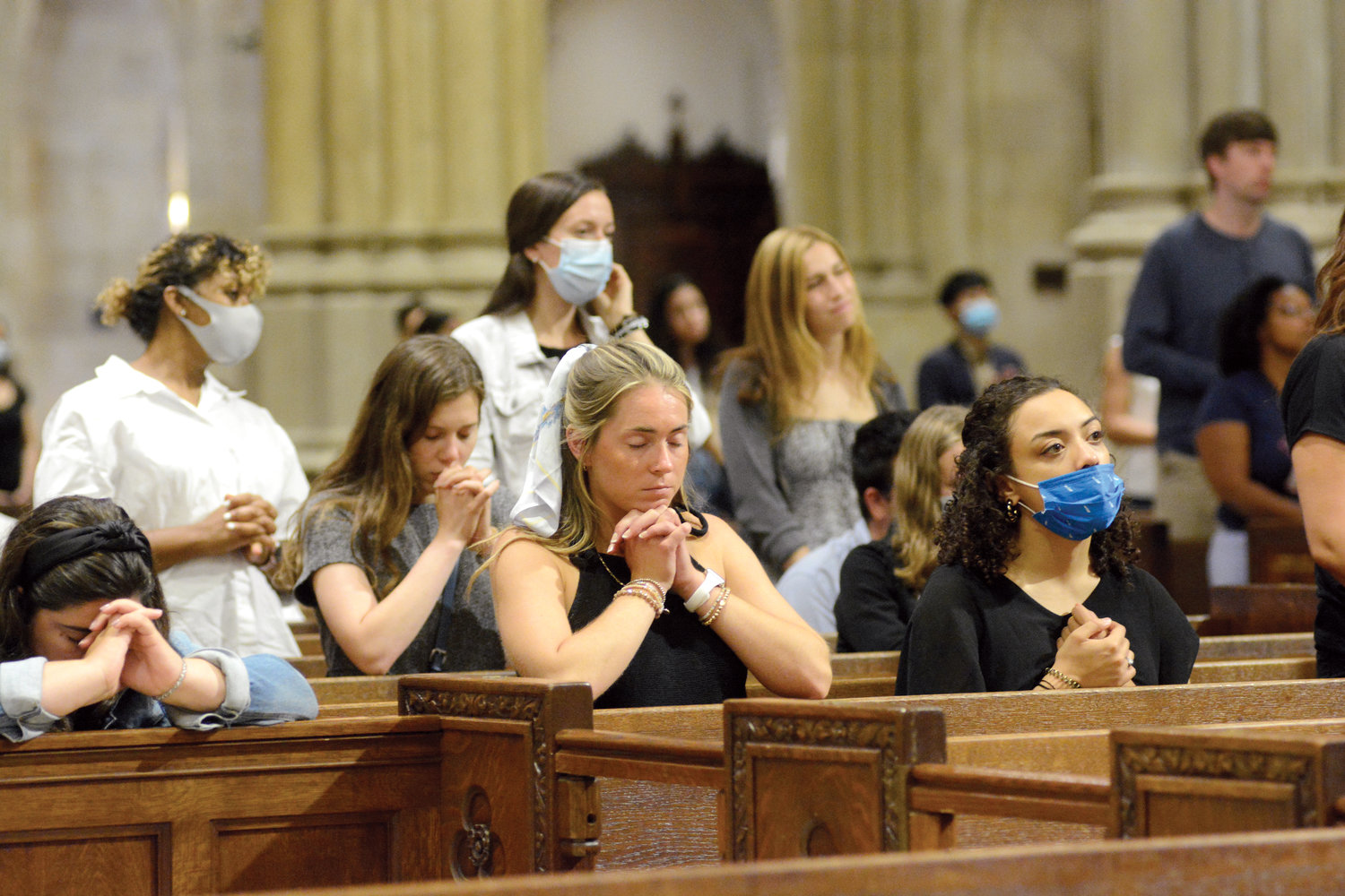 PRAYING PEACEFULLY—This serene scene was captured at the monthly Young Adult Mass at St. Patrick’s Cathedral in August. Cardinal Dolan will offer the next such Mass, on the feast of the Immaculate Conception, Wednesday, Dec. 8, at 7:30 p.m.