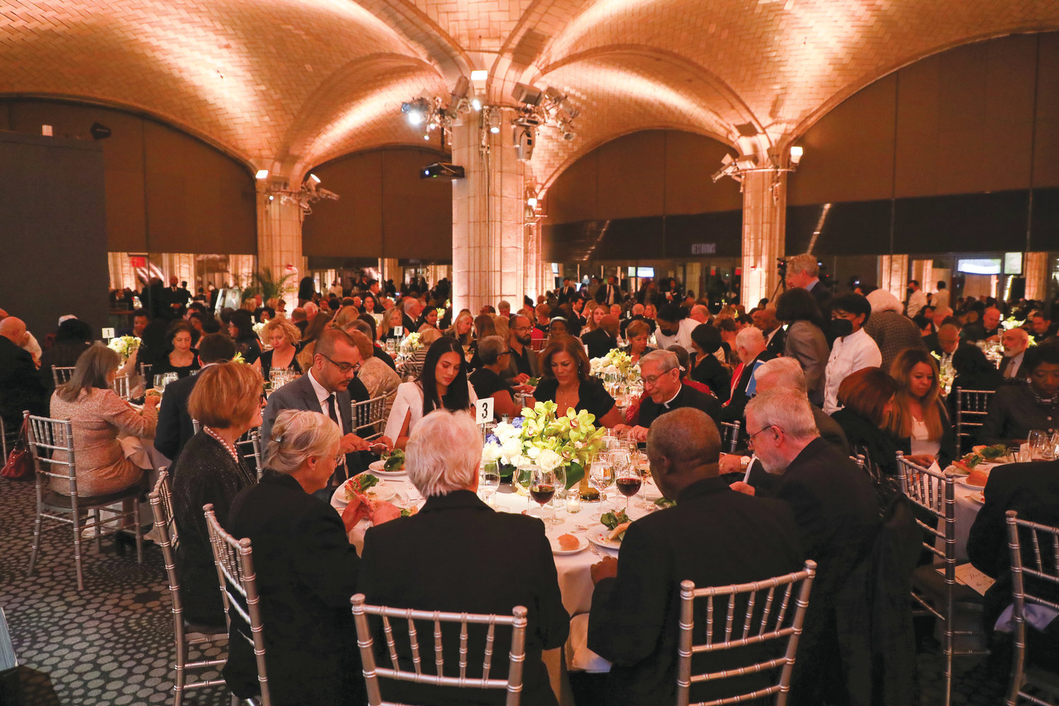 The 350 guests enjoy their meals and the convivial atmosphere at Guastavino’s in Manhattan.