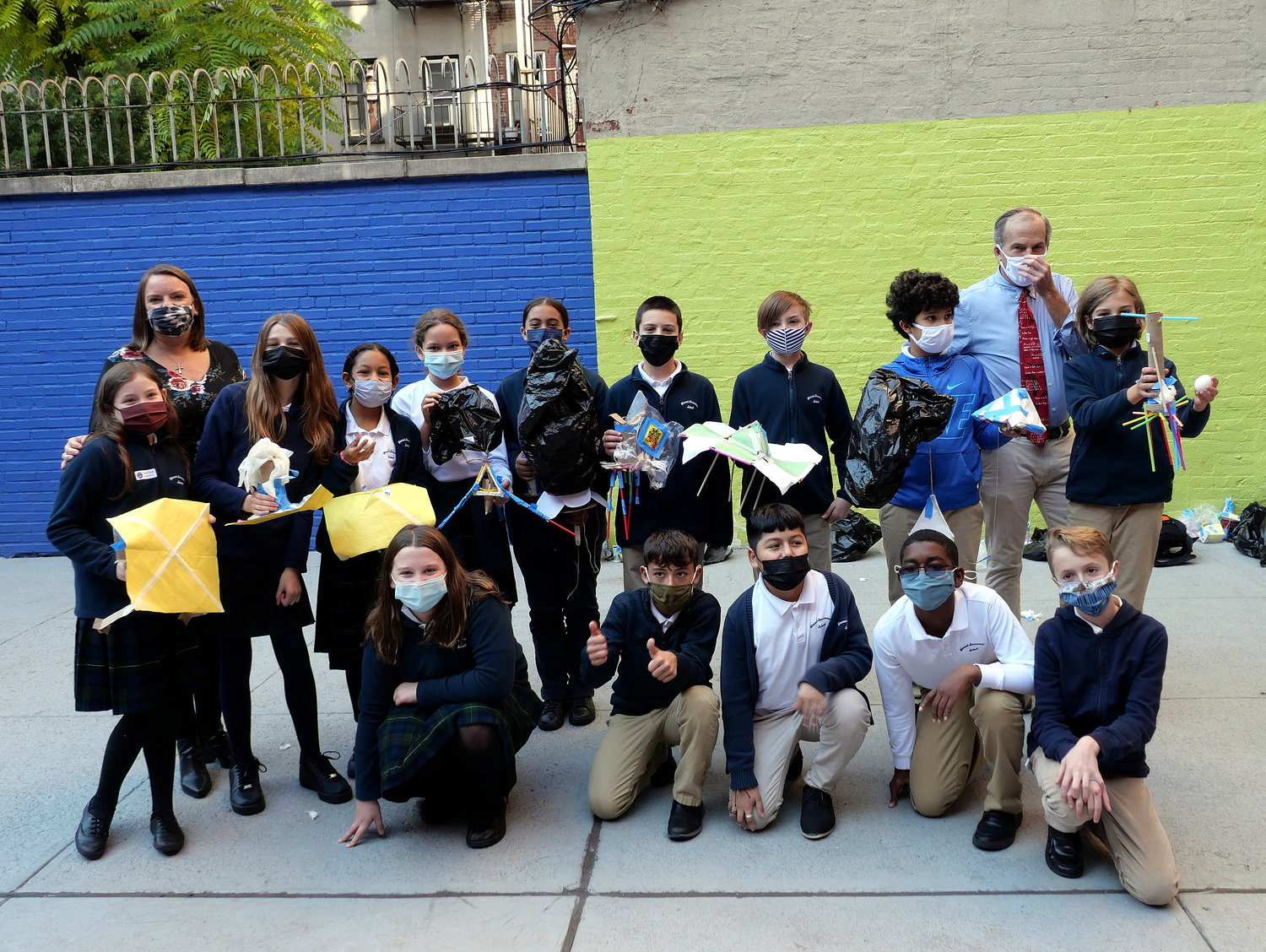A group of sixth-graders whose eggs were intact after a six-story flight join principal Megan Gonzalez and science teacher William Hawthorn at Blessed Sacrament Upper School in Manhattan. Students learning about Leonardo daVinci placed eggs in their self-made parachutes and dropped them from the roof of the school building.